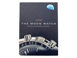Lot #14840 – Omega The Moon Watch Book The First and Only Watch Worn on the Moon Collector's Bookshelf Omega Moon Watch Book
