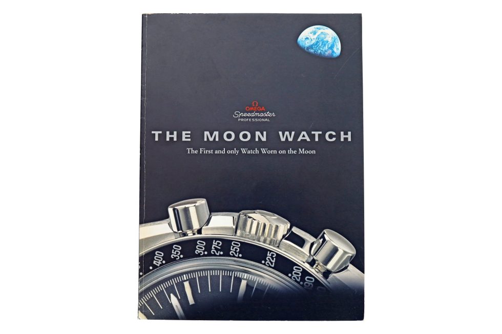 Lot #14840 – Omega The Moon Watch Book The First and Only Watch Worn on the Moon Collector's Bookshelf Omega Moon Watch Book
