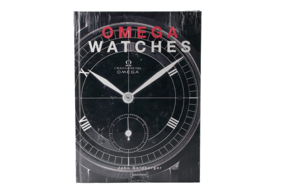 Lot #14844 – Omega Watches Book By John Goldberger Sealed Collector's Bookshelf John Goldberger