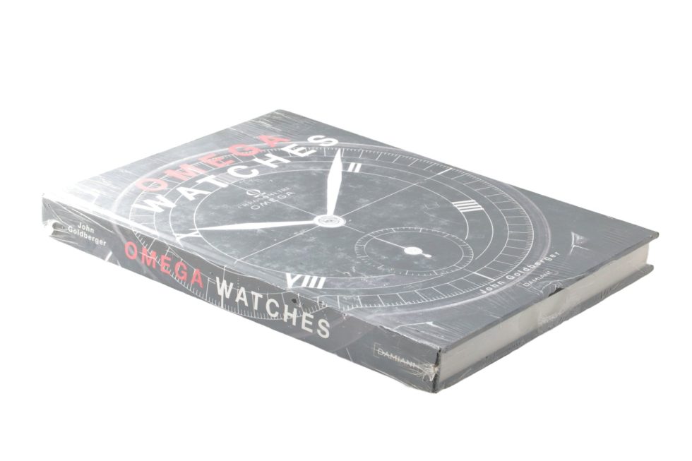 Lot #14844 – Omega Watches Book By John Goldberger Sealed Collector's Bookshelf John Goldberger