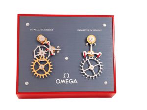 Lot #AN3835A – Omega Moving Display Co-Axial Escapement VS Swiss Lever Escapement Machine Watches Acquire Now