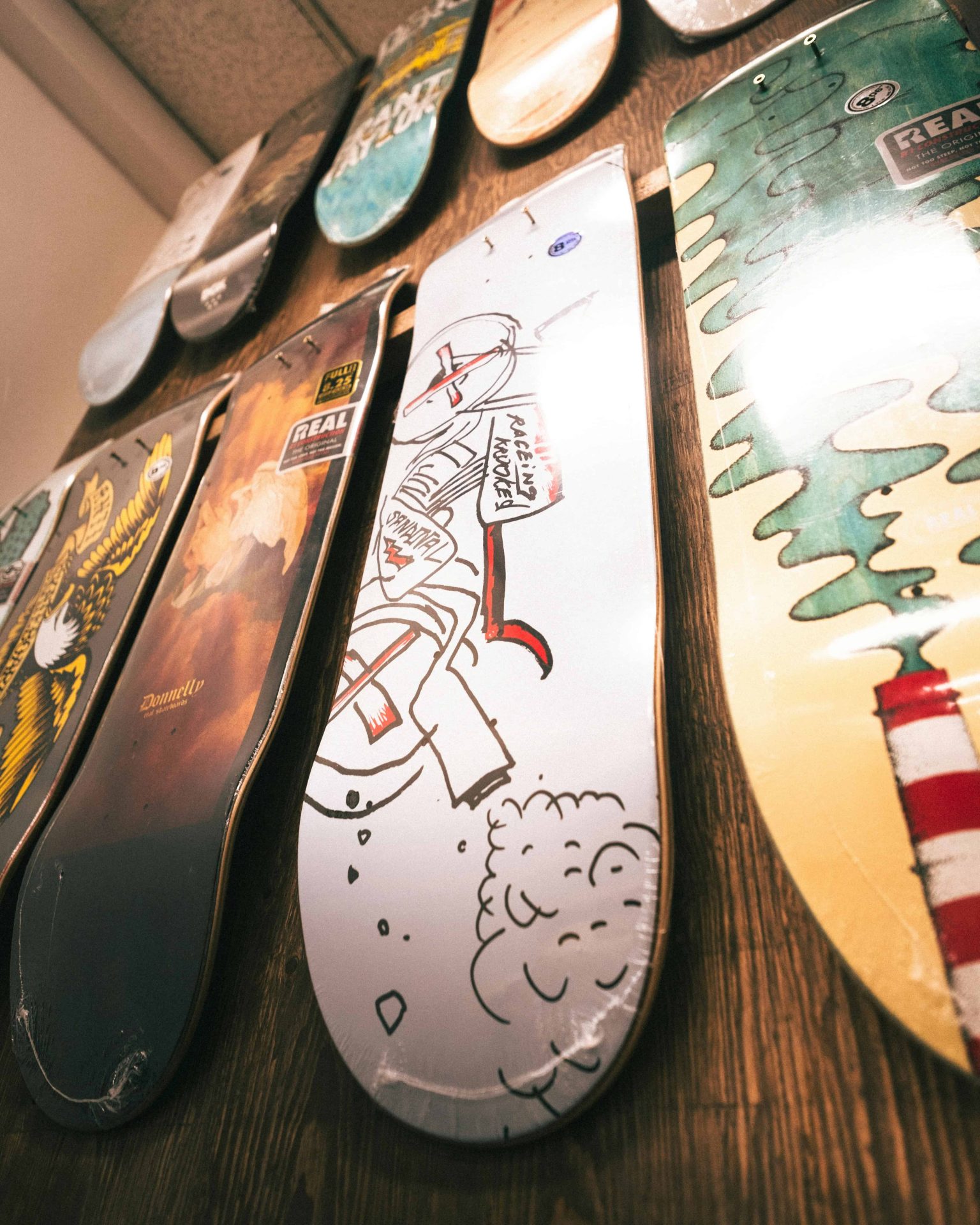 Wall display of skateboard decks showcasing unique designs